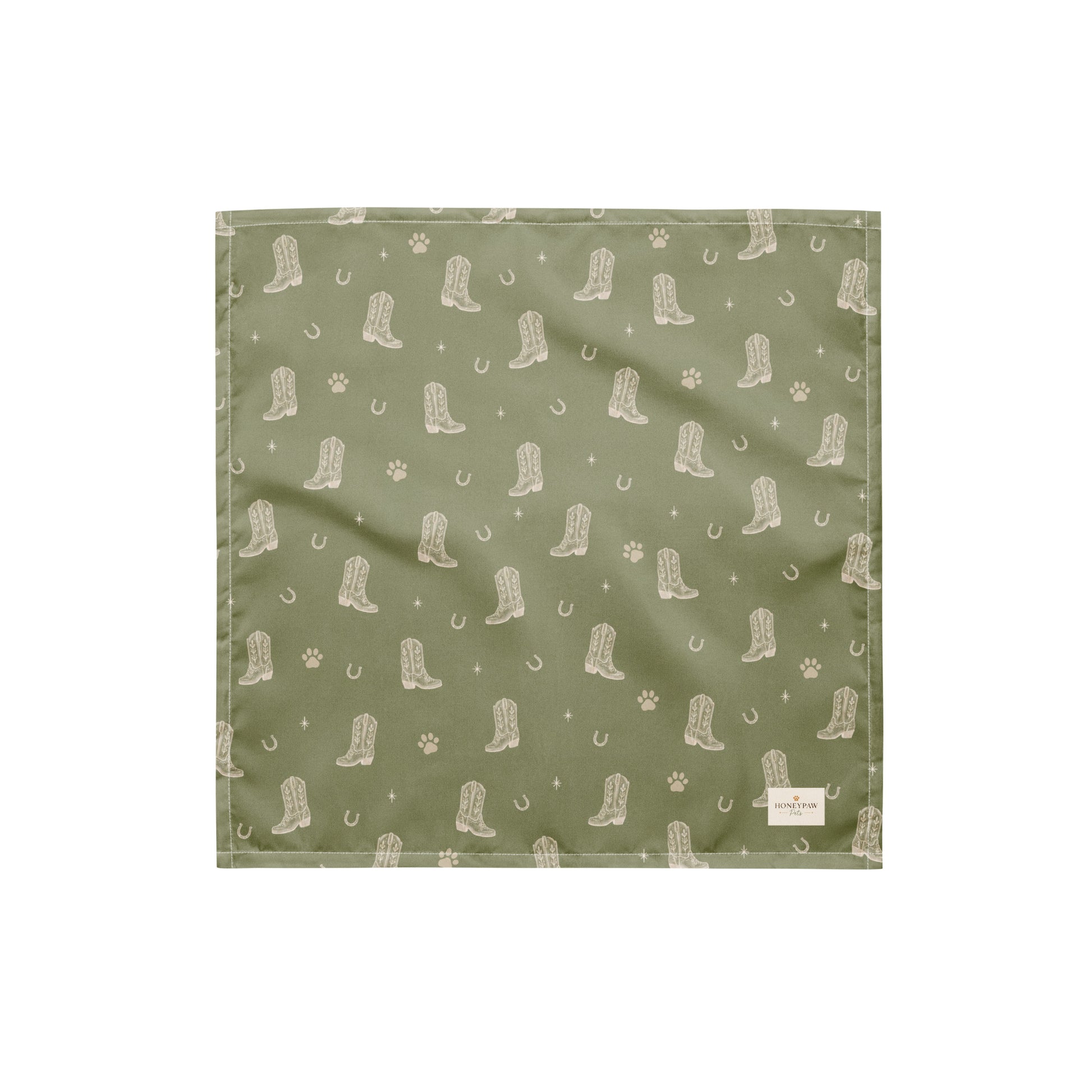 Rodeo Print western dog bandana featuring western cowboy boots, horseshoes, and paw prints on a sage green background by HoneyPaw Pets.