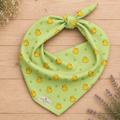 Rub-a-dub duck dog bandana featuring rubber ducks and paw prints on a green background by HoneyPaw Pets