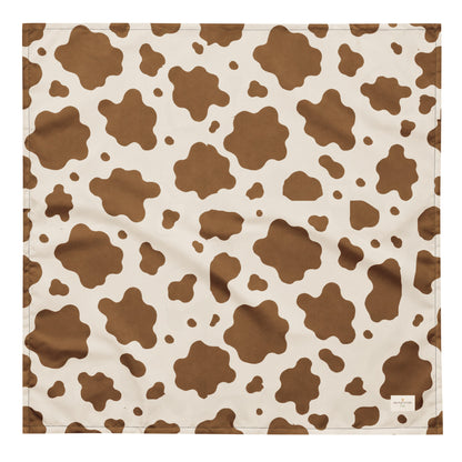 Saddle and Cattle dog bandana featuring a classic brown and cream cow print pattern inspired by western ranch style by HoneyPaw Pets.