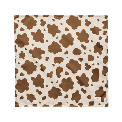 Saddle and Cattle dog bandana featuring a classic brown and cream cow print pattern inspired by western ranch style by HoneyPaw Pets.