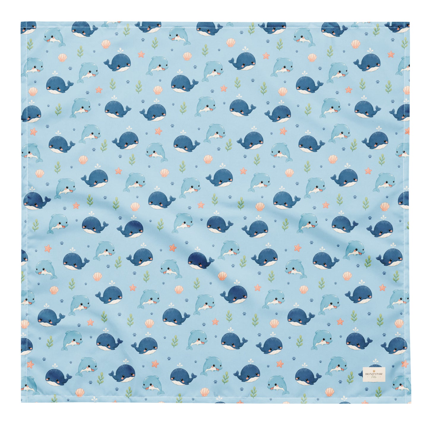 Seaside Friends ocean-themed dog bandana featuring dolphins, whales, and paw prints on a blue background by HoneyPaw Pets