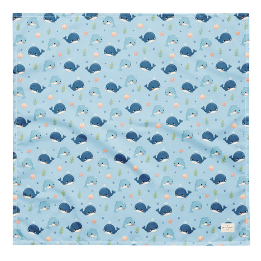 Seaside Friends ocean-themed dog bandana featuring dolphins, whales, and paw prints on a blue background by HoneyPaw Pets
