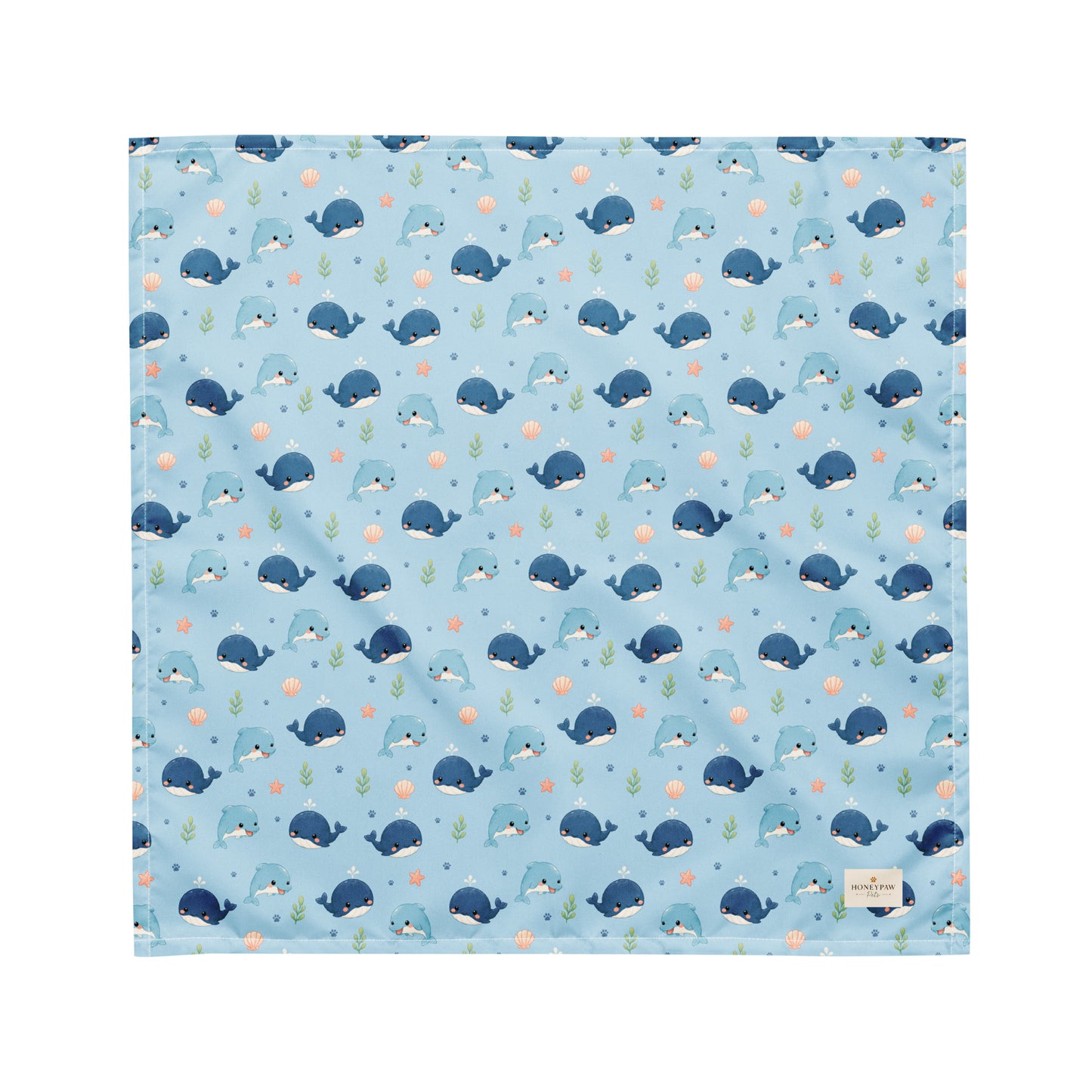 Seaside Friends ocean-themed dog bandana featuring dolphins, whales, and paw prints on a blue background by HoneyPaw Pets