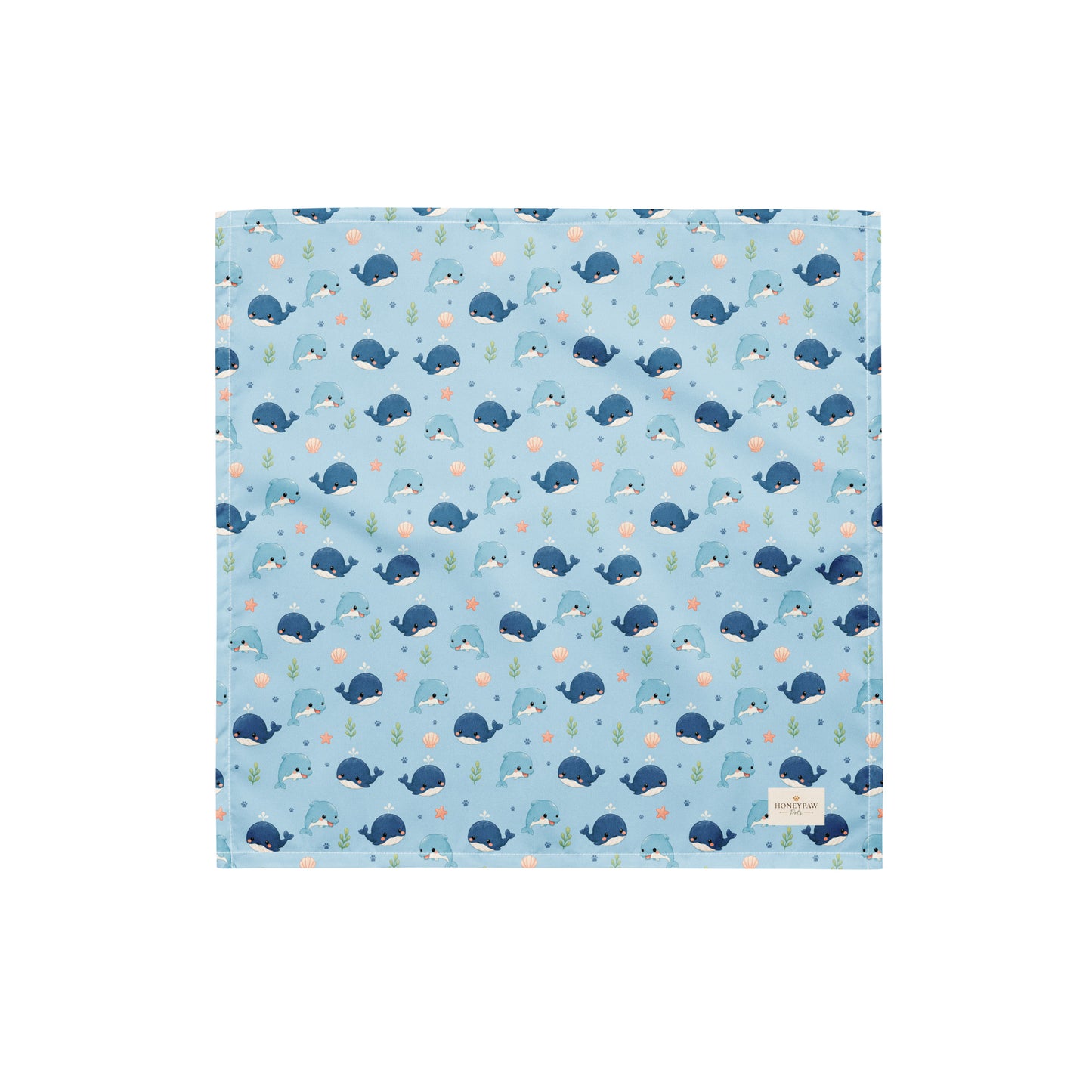 Seaside Friends ocean-themed dog bandana featuring dolphins, whales, and paw prints on a blue background by HoneyPaw Pets
