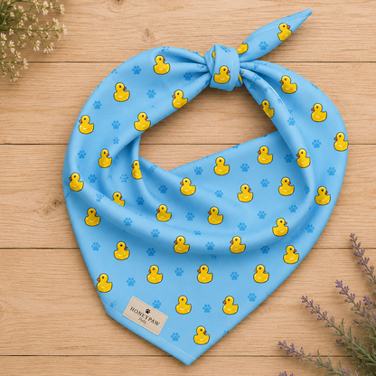 Splish Splash duck dog bandana featuring rubber ducks and paw prints on a blue background by HoneyPaw Pets