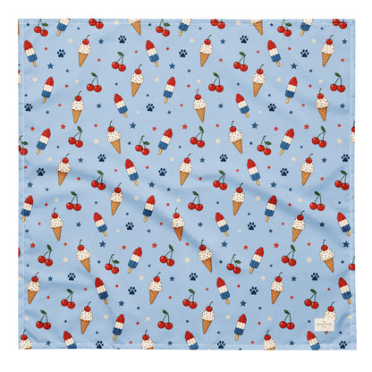 Stars and Sprinkles dog bandana featuring a patriotic ice cream and cherry pattern on a light blue background by HoneyPaw Pets.