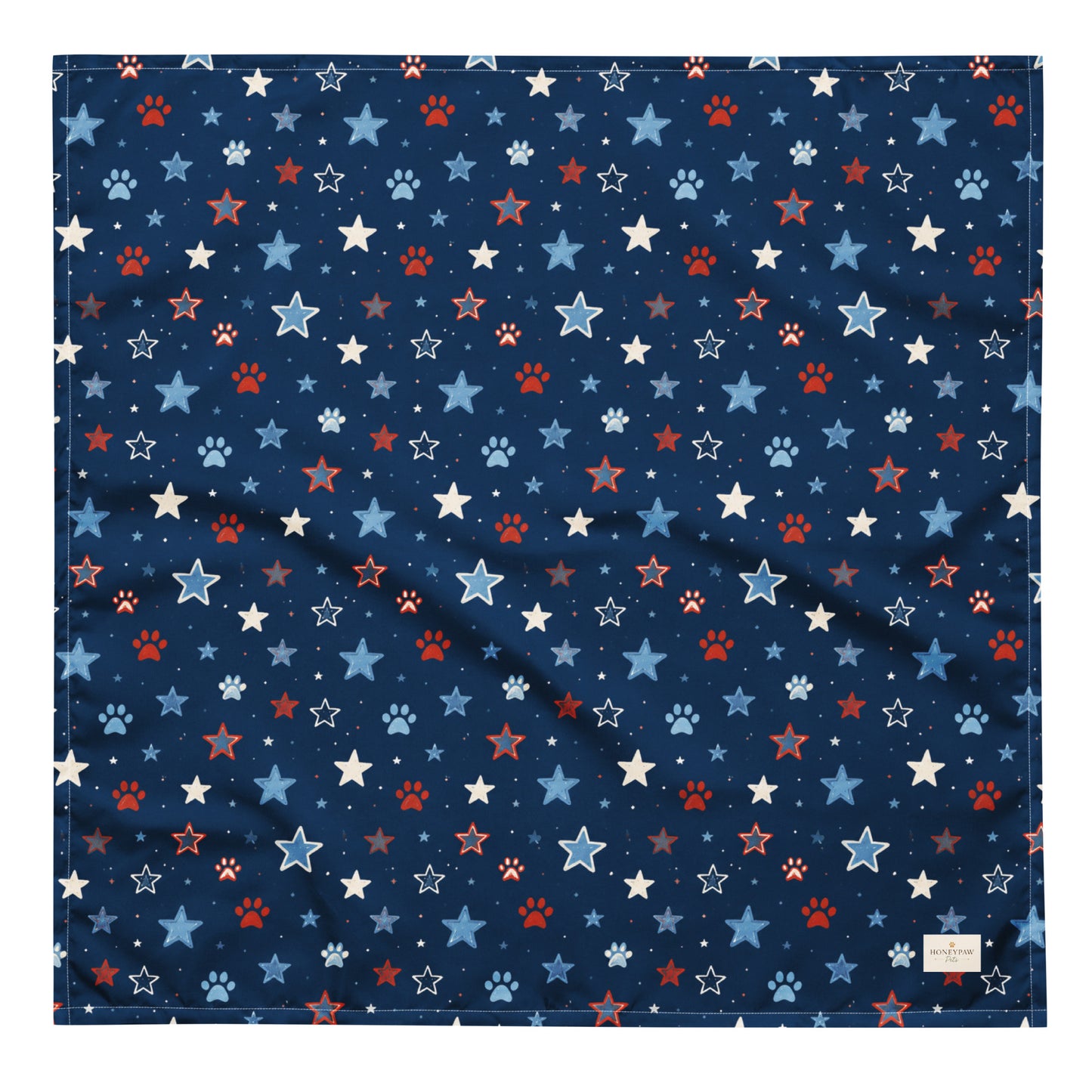 Stary Pup dog bandana featuring red, white, and blue stars with paw prints on a navy blue background by HoneyPaw Pets.