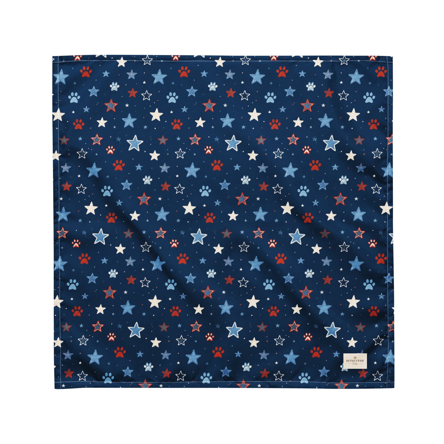 Stary Pup dog bandana featuring red, white, and blue stars with paw prints on a navy blue background by HoneyPaw Pets.