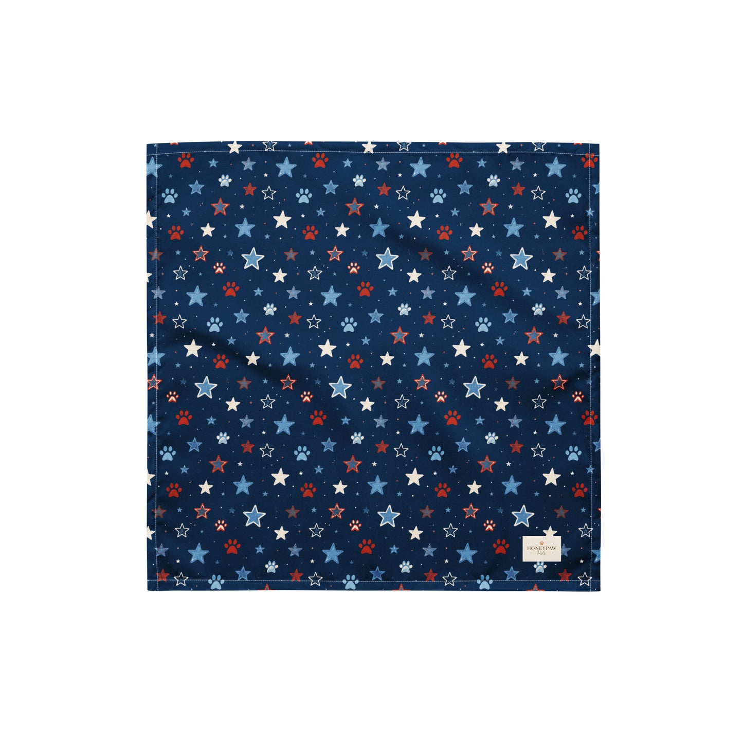 Stary Pup dog bandana featuring red, white, and blue stars with paw prints on a navy blue background by HoneyPaw Pets.