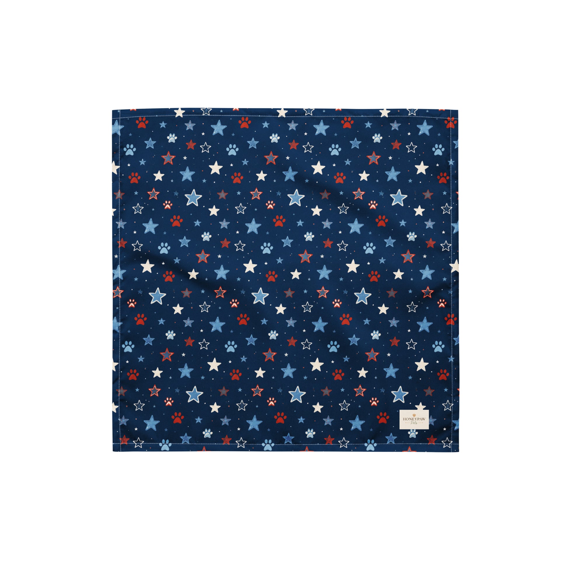Stary Pup dog bandana featuring red, white, and blue stars with paw prints on a navy blue background by HoneyPaw Pets.