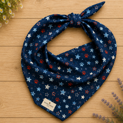 Stary Pup dog bandana featuring red, white, and blue stars with paw prints on a navy blue background by HoneyPaw Pets.