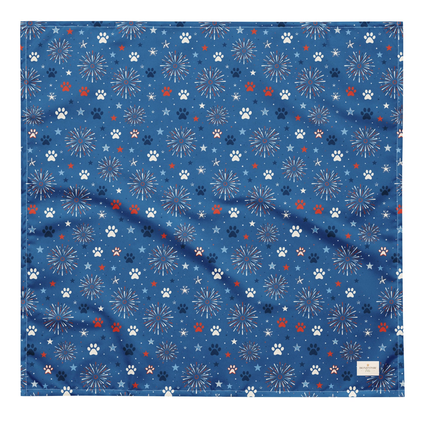 Summer Sparks dog bandana featuring red, white, and blue fireworks with paw prints on a royal blue background by HoneyPaw Pets.