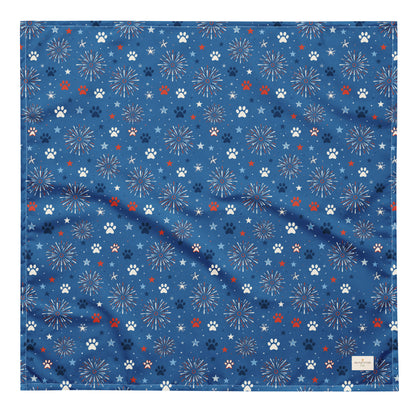 Summer Sparks dog bandana featuring red, white, and blue fireworks with paw prints on a royal blue background by HoneyPaw Pets.