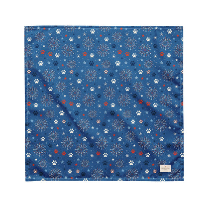 Summer Sparks dog bandana featuring red, white, and blue fireworks with paw prints on a royal blue background by HoneyPaw Pets.