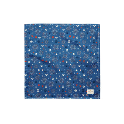 Summer Sparks dog bandana featuring red, white, and blue fireworks with paw prints on a royal blue background by HoneyPaw Pets.