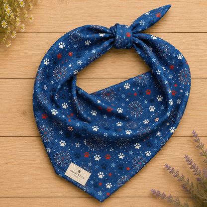 Summer Sparks dog bandana featuring red, white, and blue fireworks with paw prints on a royal blue background by HoneyPaw Pets.