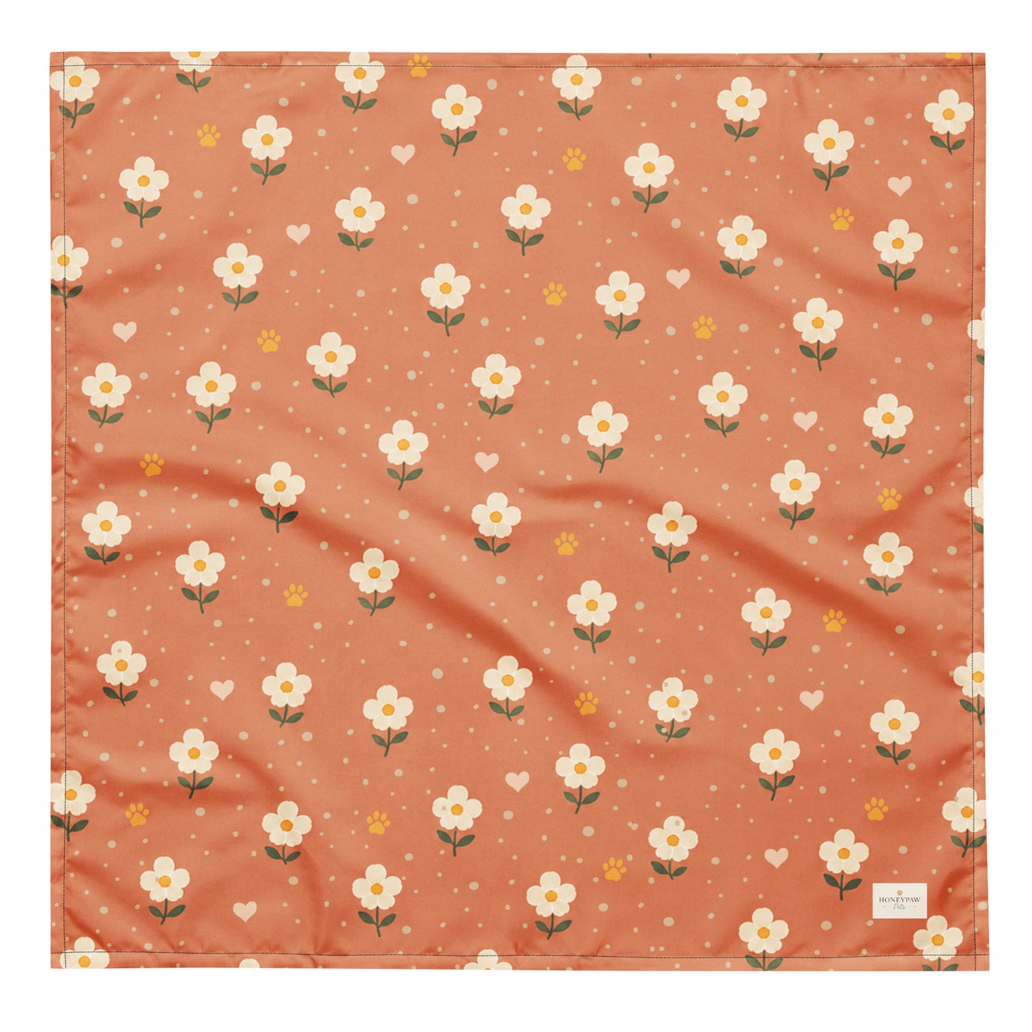 Terracotta Paws dog bandana featuring cream floral blooms, golden paw prints, and tiny hearts on a terracotta background by HoneyPaw Pets.