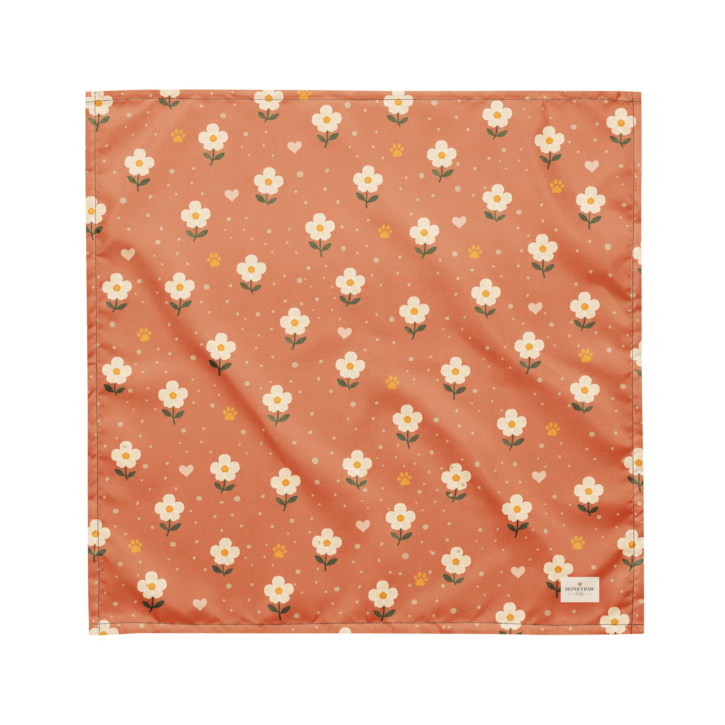 Terracotta Paws dog bandana featuring cream floral blooms, golden paw prints, and tiny hearts on a terracotta background by HoneyPaw Pets.