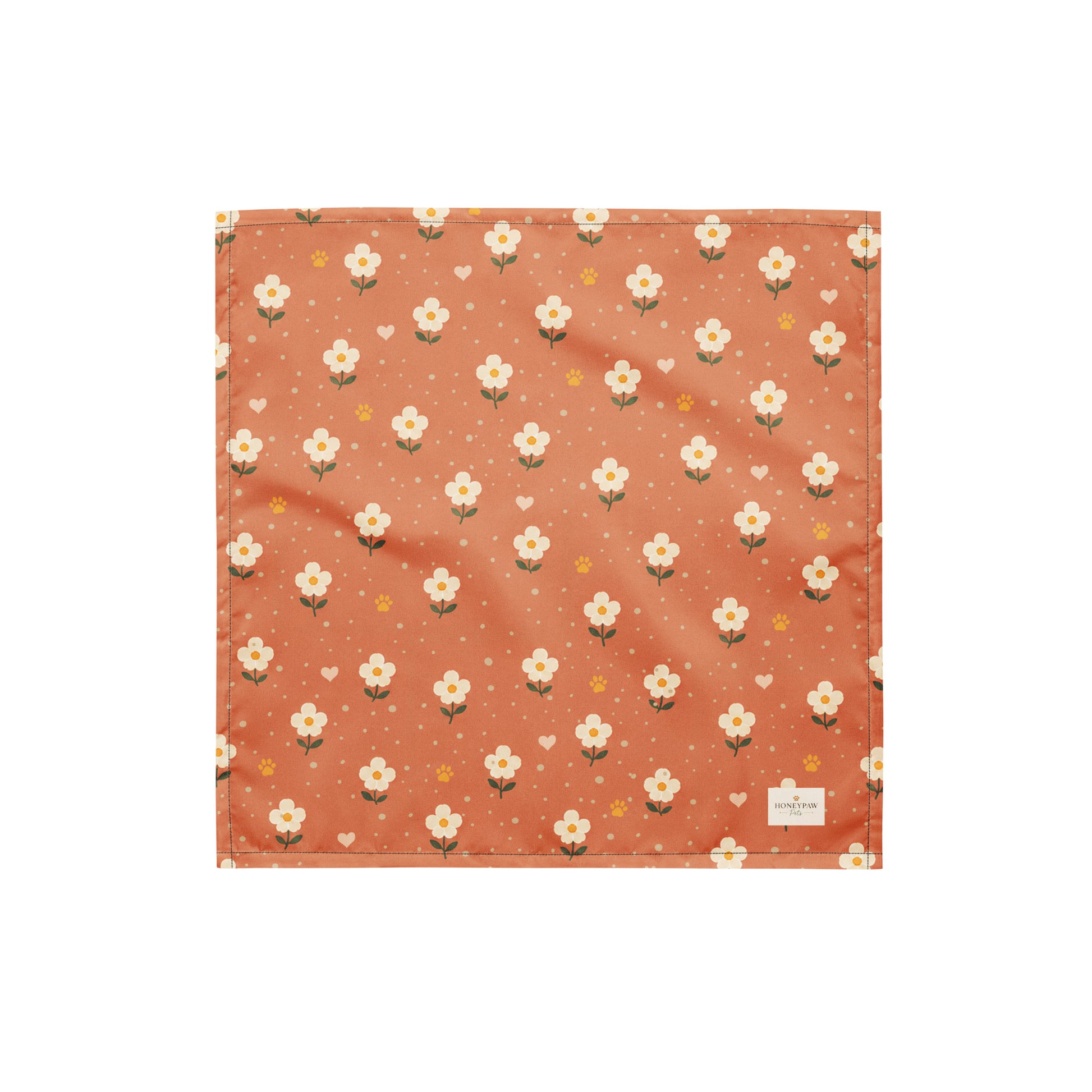 Terracotta Paws dog bandana featuring cream floral blooms, golden paw prints, and tiny hearts on a terracotta background by HoneyPaw Pets.