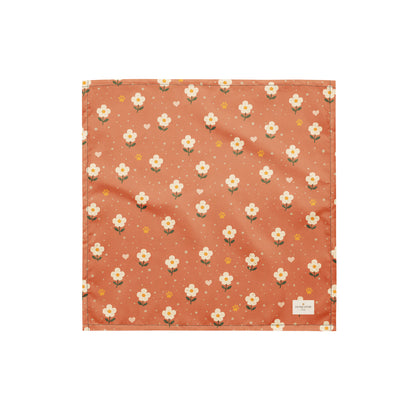 Terracotta Paws dog bandana featuring cream floral blooms, golden paw prints, and tiny hearts on a terracotta background by HoneyPaw Pets.