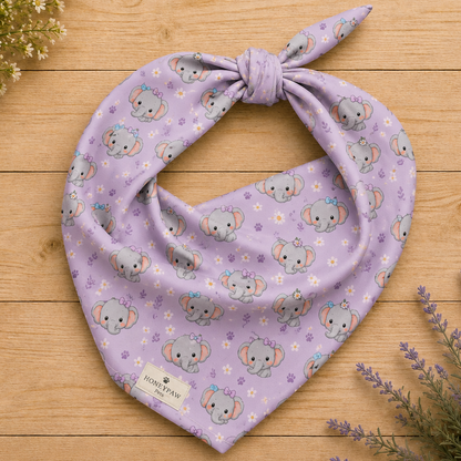 Tiny Tusks dog bandana featuring elephant faces and paw prints on a lavender background by HoneyPaw Pets