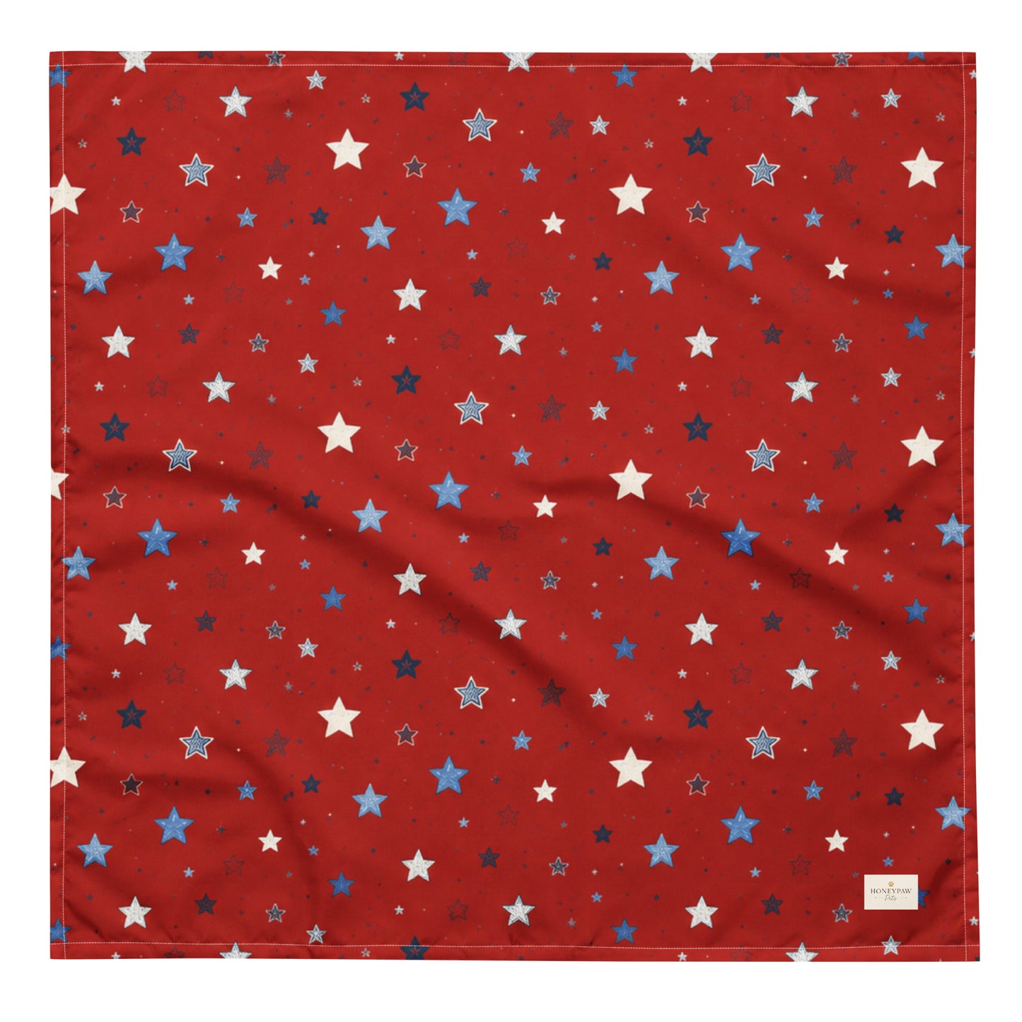 Twinkle Tails dog bandana featuring a patriotic star pattern on a red background by HoneyPaw Pets.