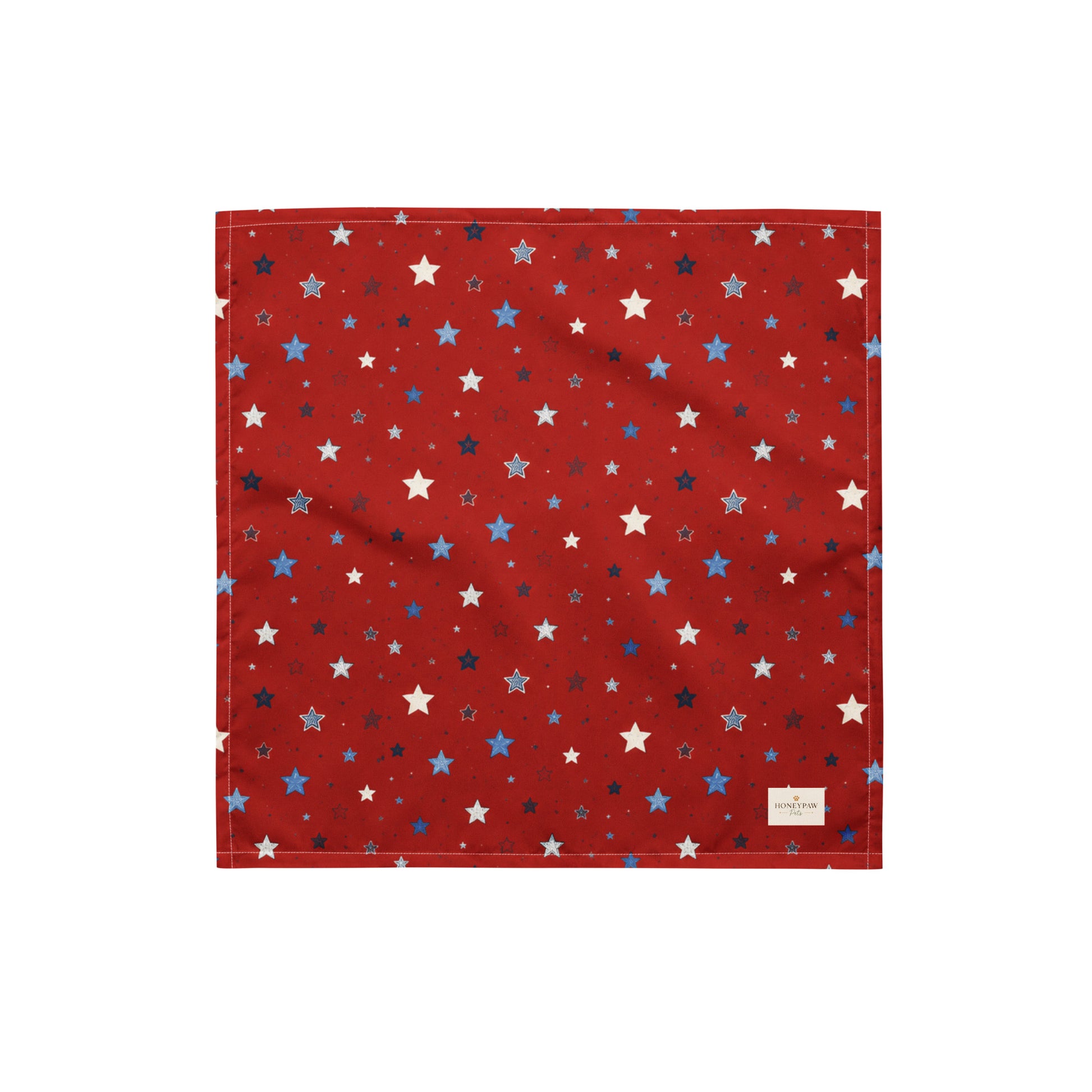 Twinkle Tails dog bandana featuring a patriotic star pattern on a red background by HoneyPaw Pets.