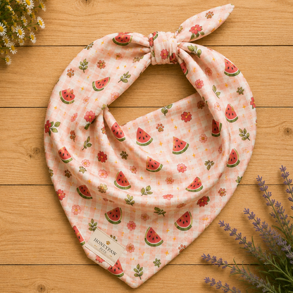 Watermelon Wiggles dog bandana featuring juicy watermelon slices, floral accents, and a soft pink plaid pattern on a cream background by HoneyPaw Pets.